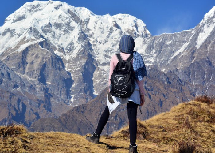 person carrying black backpack across white mountain